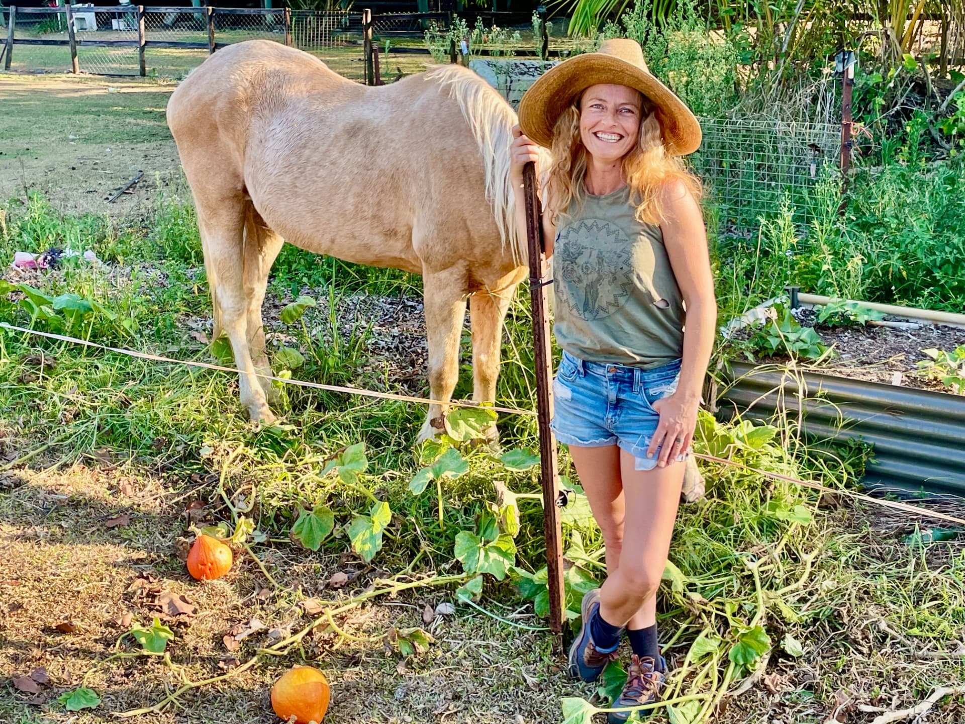 Elle holding pumpkins harvested from her garden